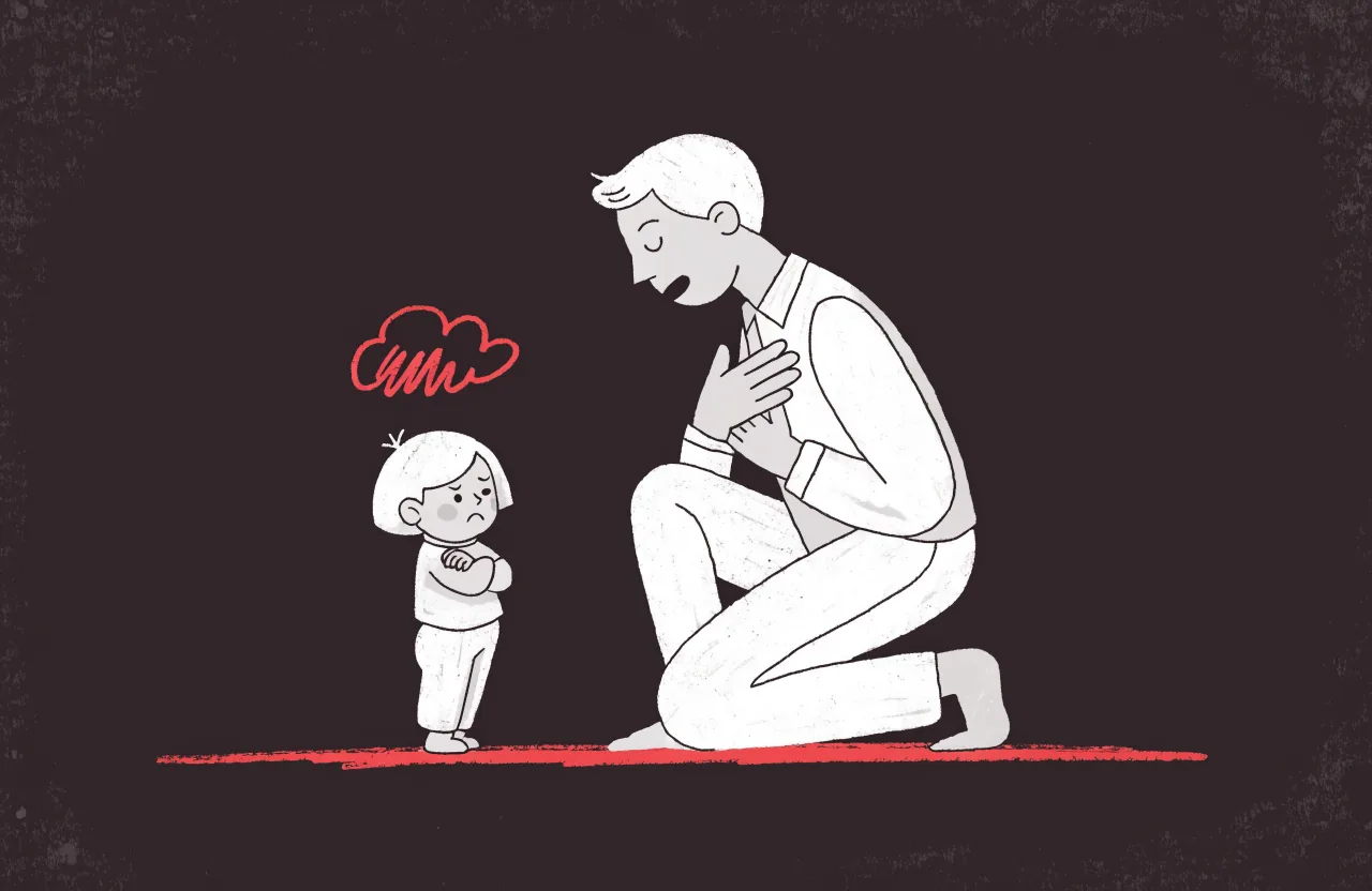 How to discipline a toddler: calm dad kneeling to eye level with a defiant toddler